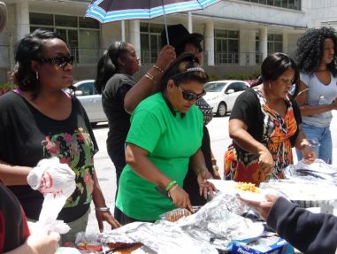 Dr. Angie Eugene is serving a meal to member of the homeless community in Atlanta, GA